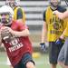 A Saline High School quarterback looks to throw the ball during practice at the school on Monday, August 12, 2013. Melanie Maxwell | AnnArbor.com